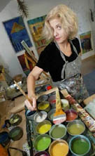 Photo of encaustic painter Cynthia Schildhauer in her studio